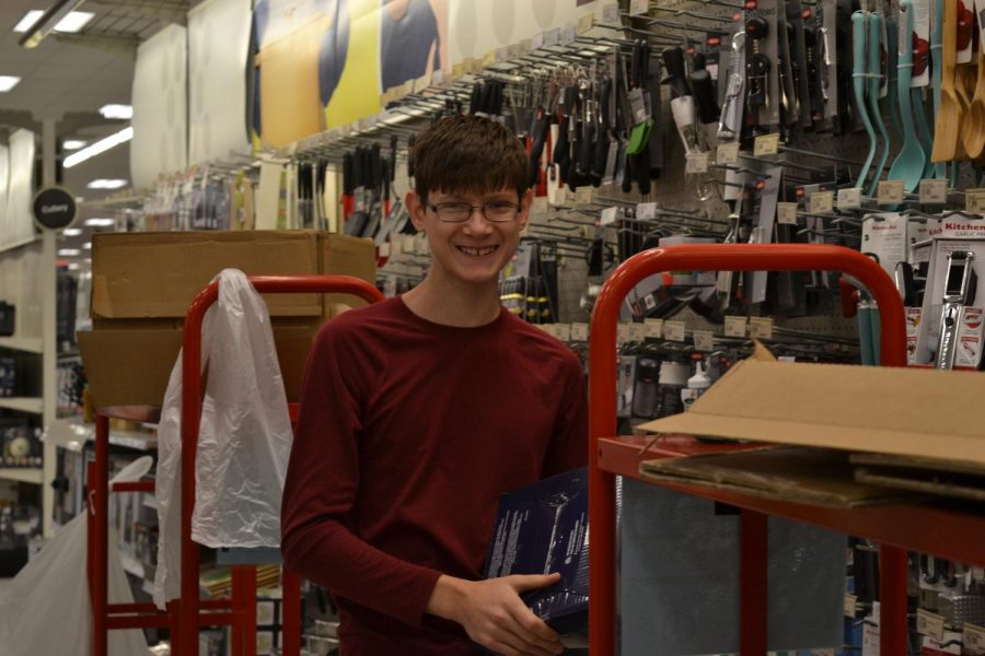 Edward Leevy (10) smiling for a picture while unloading boxes