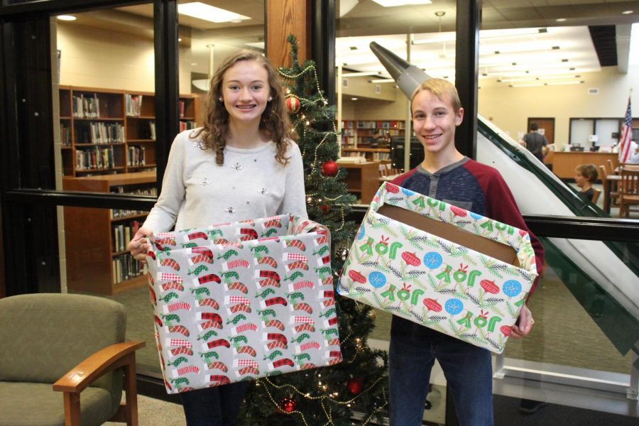 Encouraging fellow classmates, Claire Kriner (11) and Timothy Helman (9) get excited for the holiday season. 