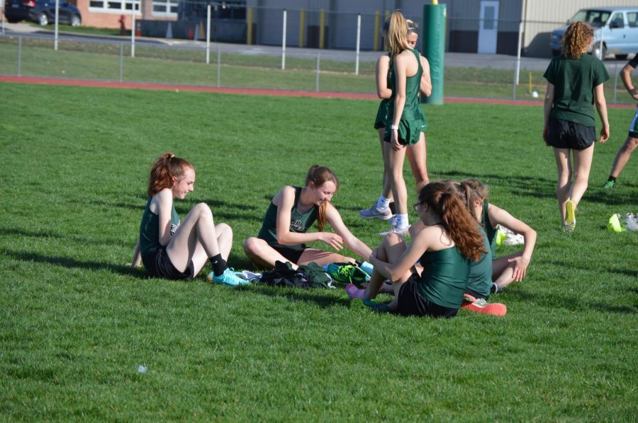 Stretching, some of the sprinters relax after their races were complete.