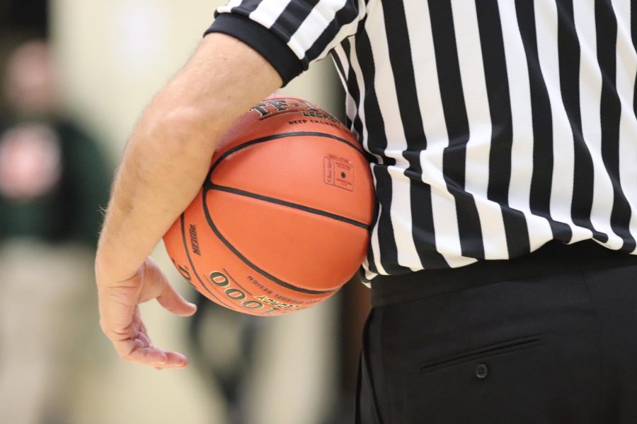 After traveling out of bounds, the ball rests in the referees hands before being passed into play.