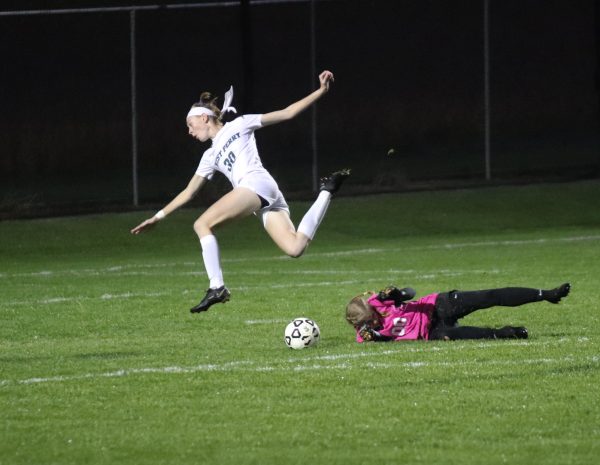 Diving to protect the goal, Senior Izzy Hoffeditz trips up the West Perry striker.  Hoffeditz was successful in pushing the striker wide of the goal. 