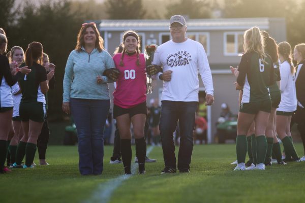 Walking her way down the field, Izzy Hoffeditz was accompanied by her mom and dad as well as  her surrounding teammates and coaches. They all came together to celebrate Hoffeditz accomplishments.

