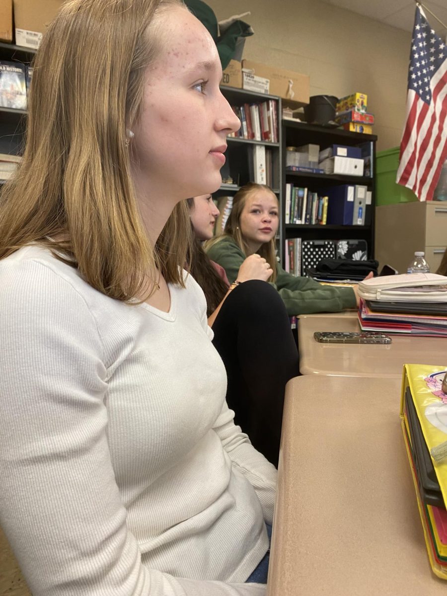 Listening to a class discussion during a Student Council meeting, Alana Mickley (10), Lilly Garbinski (10), and Peyton Saunders (10) consider whether the Senior Send-off Dance should be held indoors or outdoors.